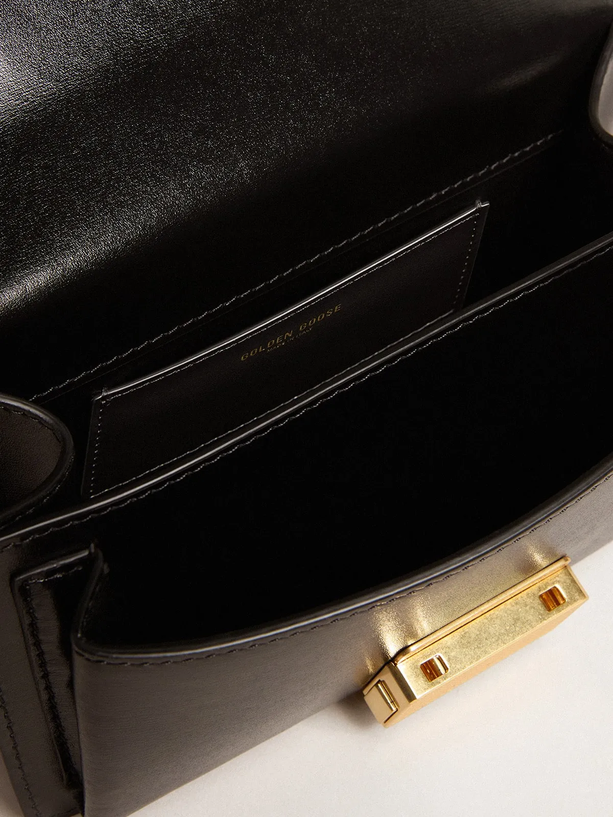 Small Venezia Bag in black boarded leather with gold details